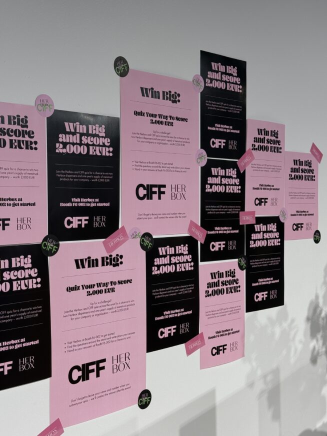 A picture of Herbox posters at the Bella Center (CIFF 2025). The posters are pink and black and states that the lucky winner will win 2000€ worth of Herbox products.