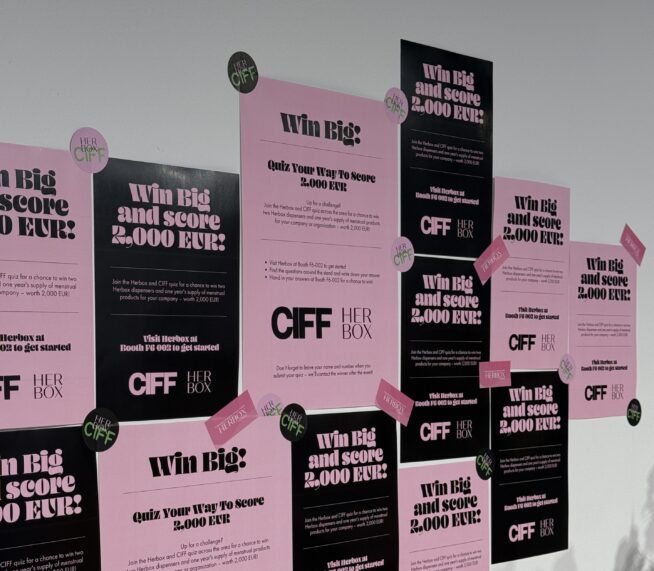 A picture of Herbox posters at the Bella Center (CIFF 2025). The posters are pink and black and states that the lucky winner will win 2000€ worth of Herbox products.